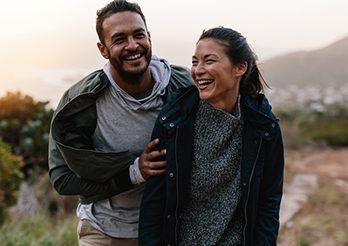 couple in jackets walking on path